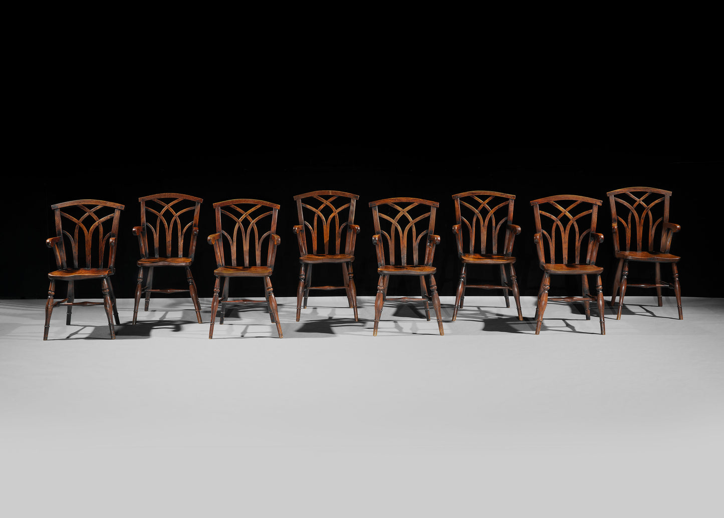 A Spectacular Matched Set of Sixteen Gothic Lace Back Windsor Chairs