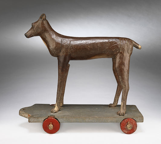 An Extraordinary Stylised Primitive Carving of a Hound