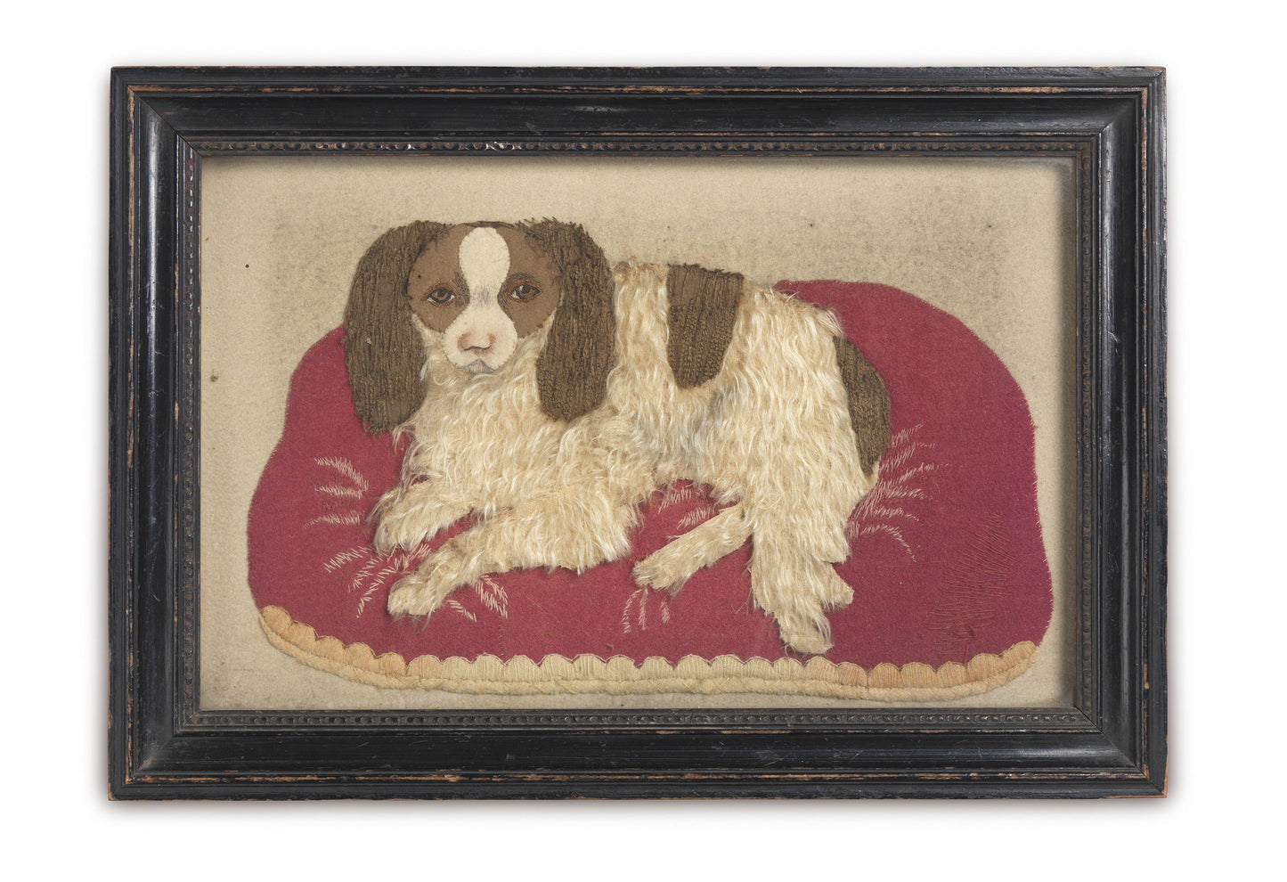 Spaniel Lying On A Red Cushion